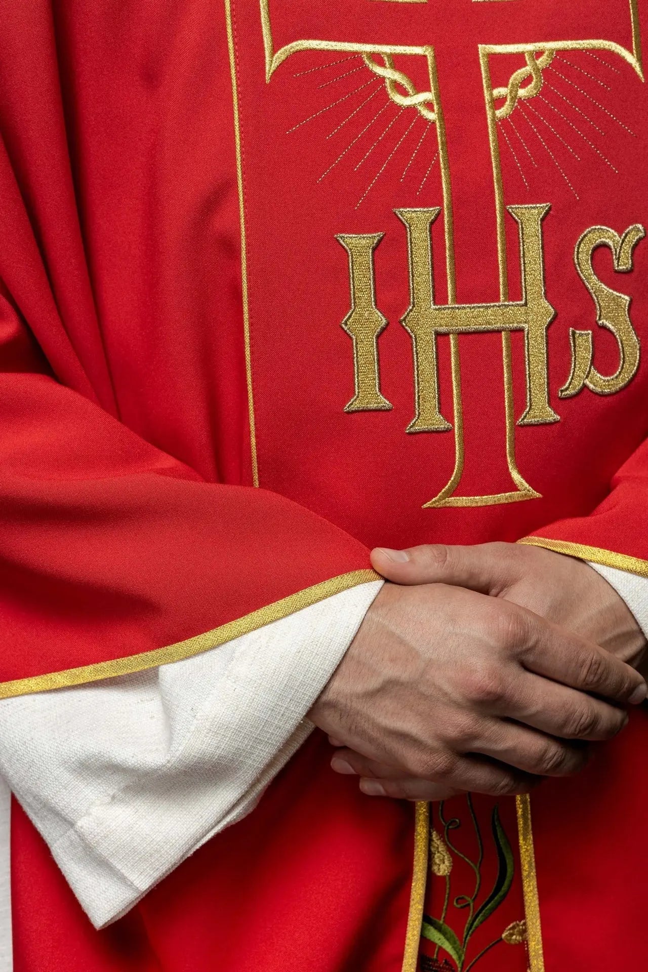 Red chasuble with decorated gold belt with IHS and ears