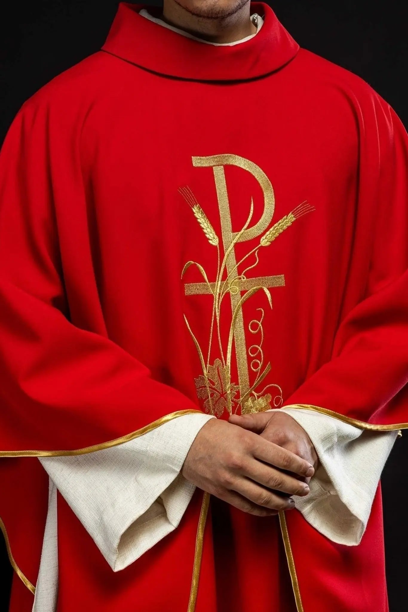 Czerwony ornat z haftowanym złotym krzyżem