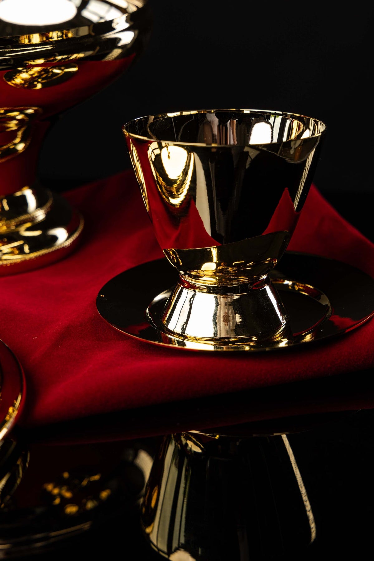 Gold-plated brass ciborium with cross finial and matching cup, close-up