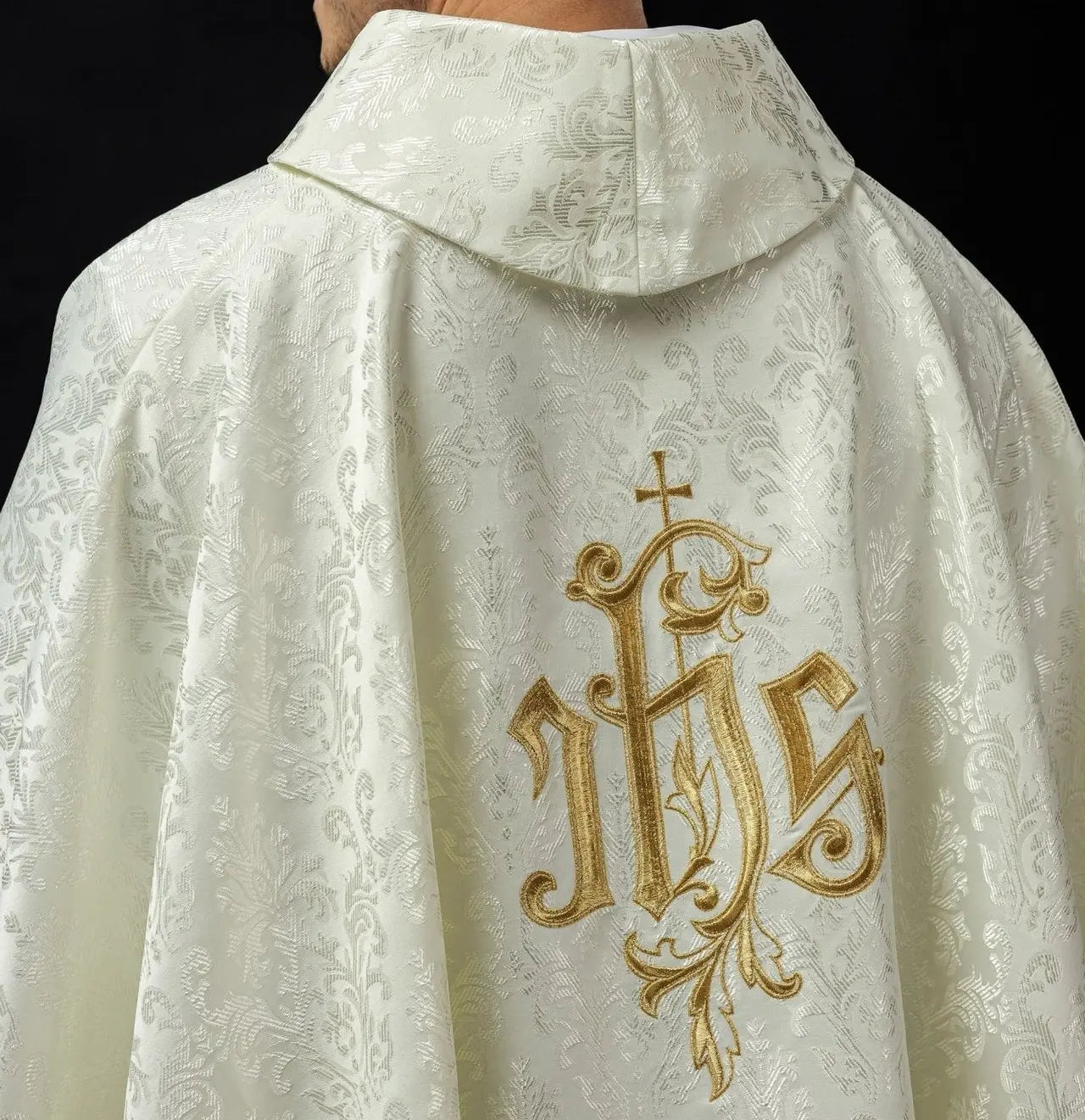 Ecru chasuble with embroidered IHS motif on decorative fabric