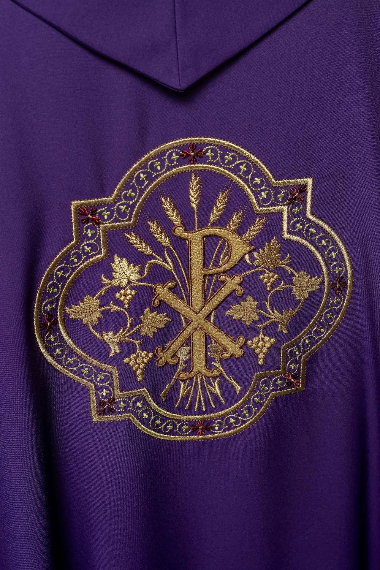 Purple chasuble with IHS and PAX embroidery