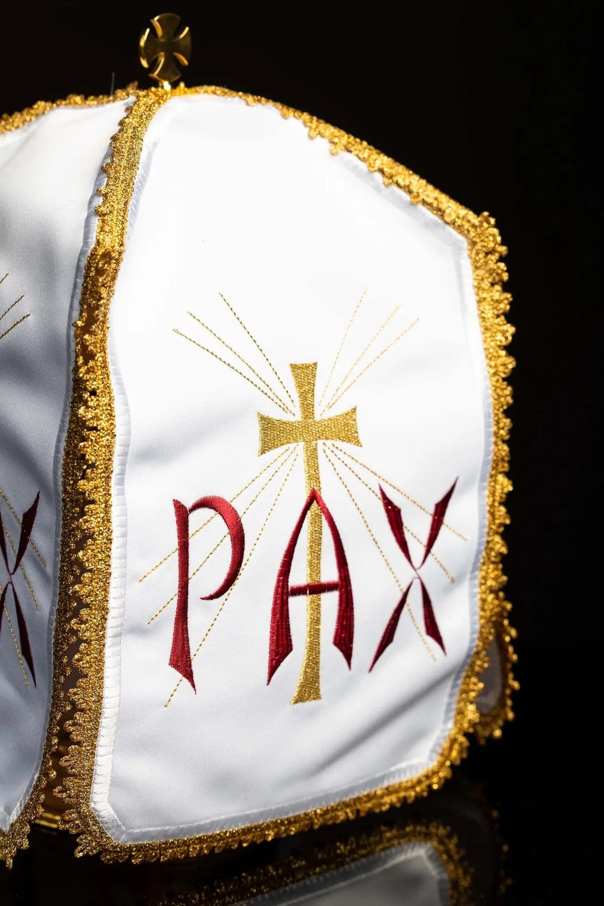 Biały welon na puszkę z haftem PAX i krzyżem promienistym, widok z boku