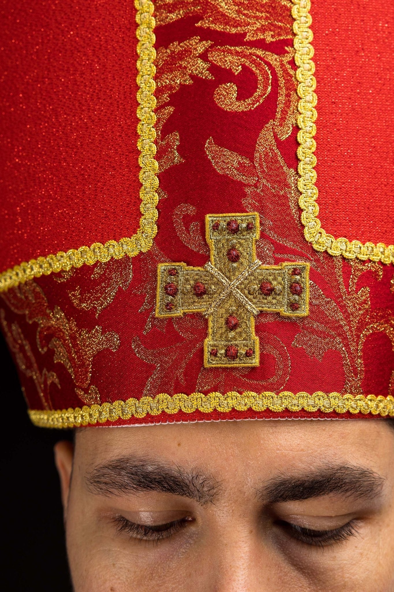 Red embroidered mitre with a cross motif and decorative jacquard fabric