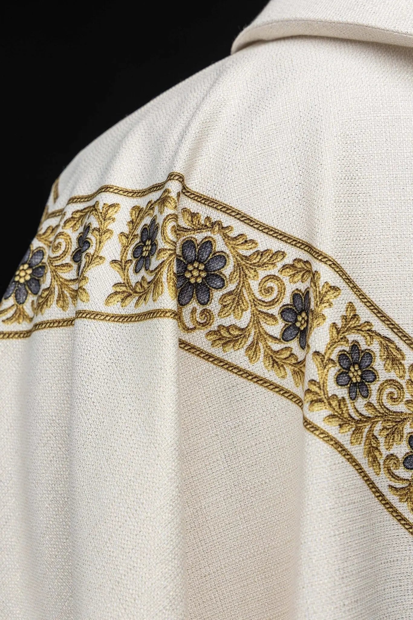 Ecru chasuble with printed image of Our Lady of Lourdes, featuring a blue sash and gold floral motifs, with a matching stole.