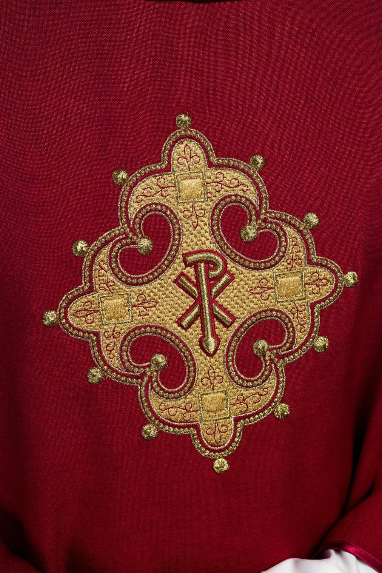 Chasuble with embroidered cross and gold trim on collar in red