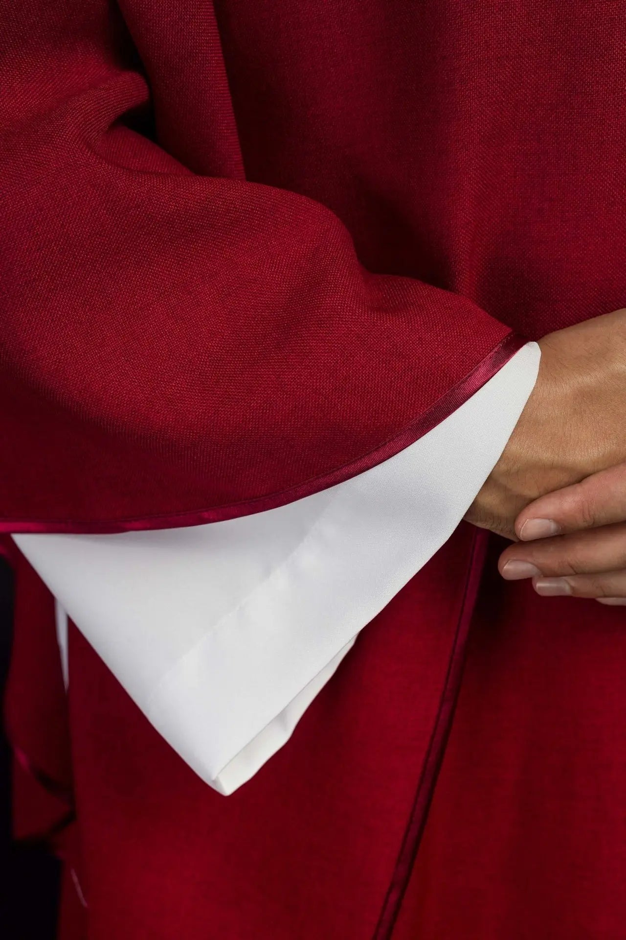 Chasuble with embroidered cross and gold trim on collar in red