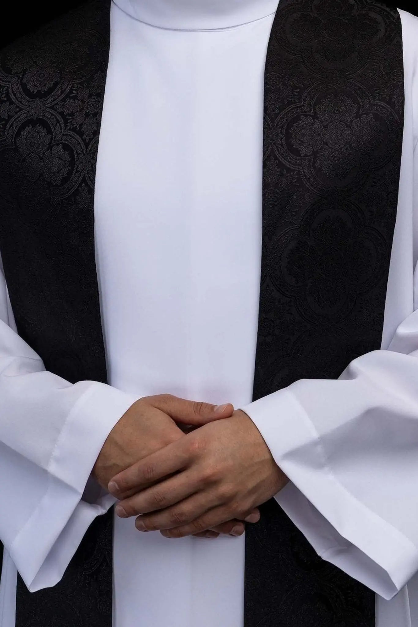 Black jacquard stole with embroidered gold crosses for liturgical use.