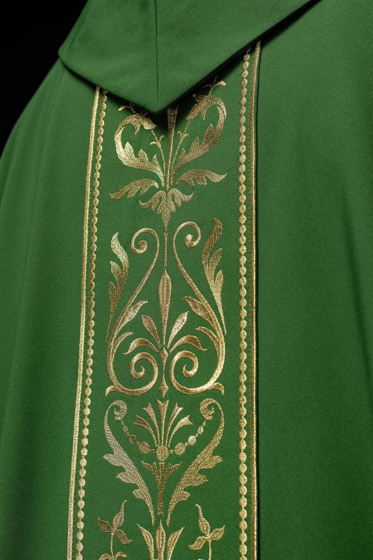 Green liturgical chasuble decorated with gold embroidered belt